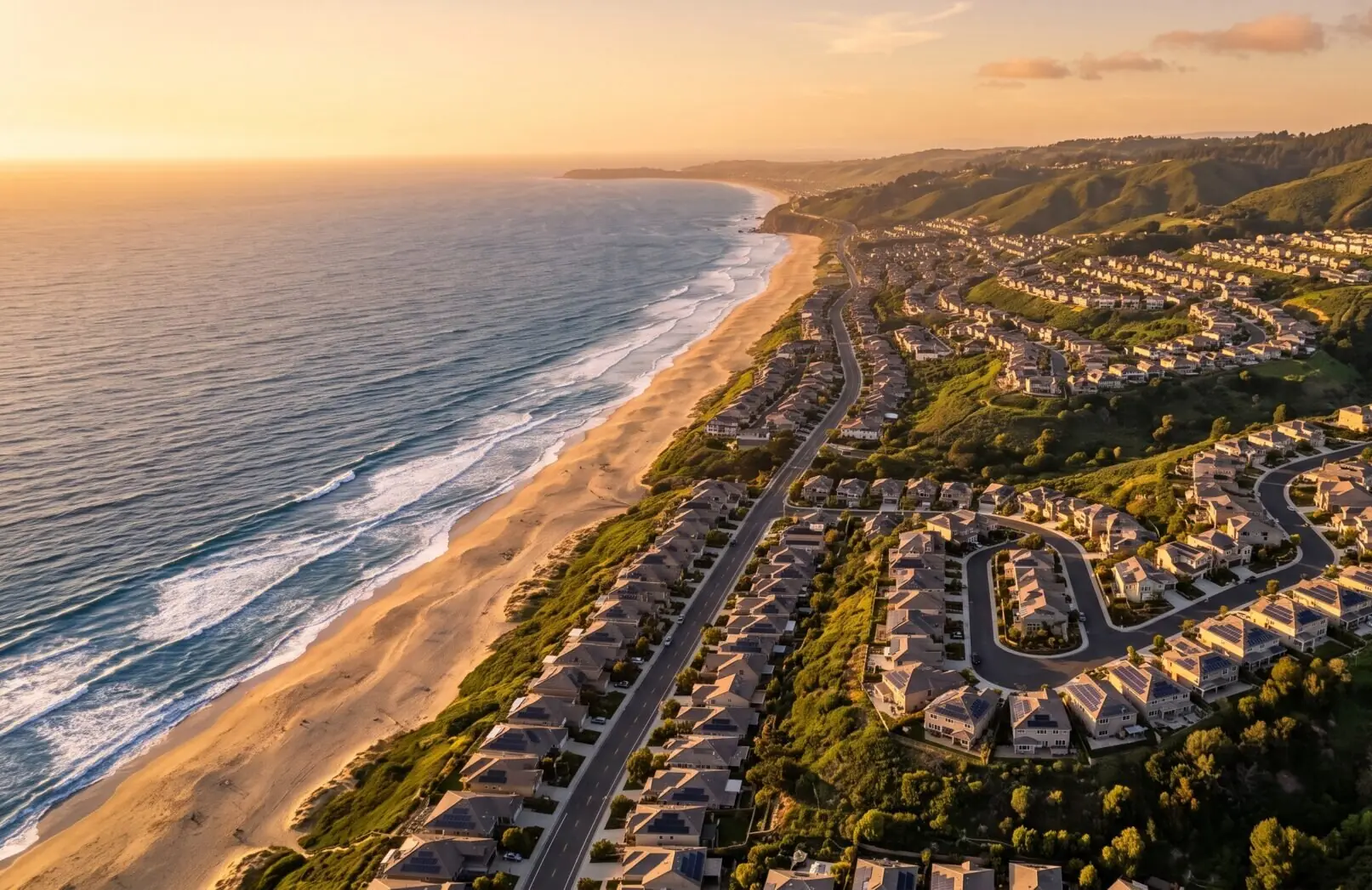 Aerial view of a California coastal neighborhood with rooftop solar at golden hour